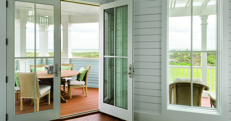 Hinged French doors provide easy entry from the porch in a Victorian home